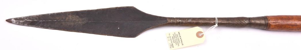 A spear, slender leaf shaped blade and long socket with bands and a small section of cross hatch