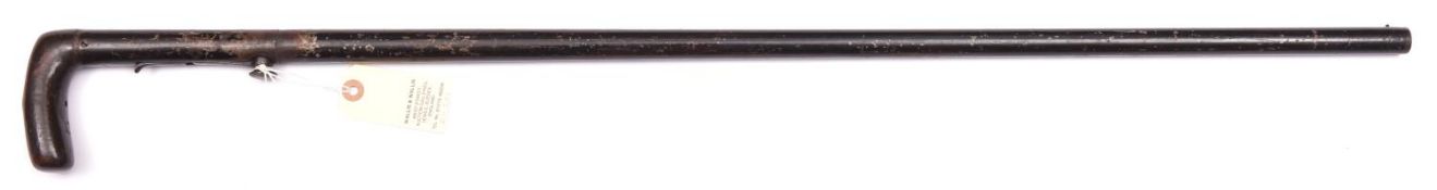 A 24 bore percussion under hammer walking stick gun, barrel 28” with button fore sight, the wooden