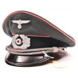 A Third Reich Panzer officer’s peaked cap, with aluminium eagle and cockade, pink piping, silver