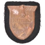 A Third Reich Kuban shield, with black cloth patch and original paper backing. GC (small patch of