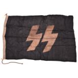 A Third Reich SS printed linen flag, 34” x 59”, the hoist stamped with SS runes, “Wewelsburg 1944”