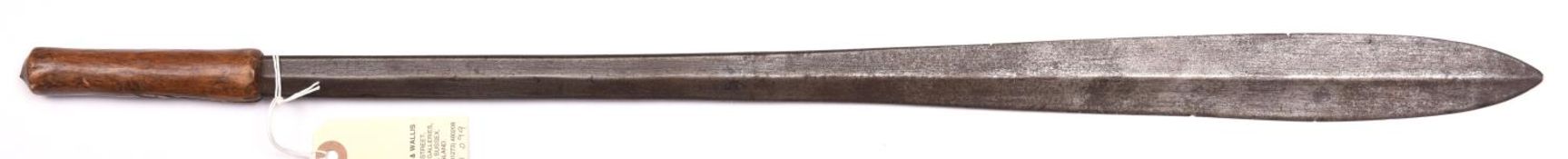 A Masai sword, seme, heavy, hollow diamond section blade 23”, swollen at point, plain wooden grip (