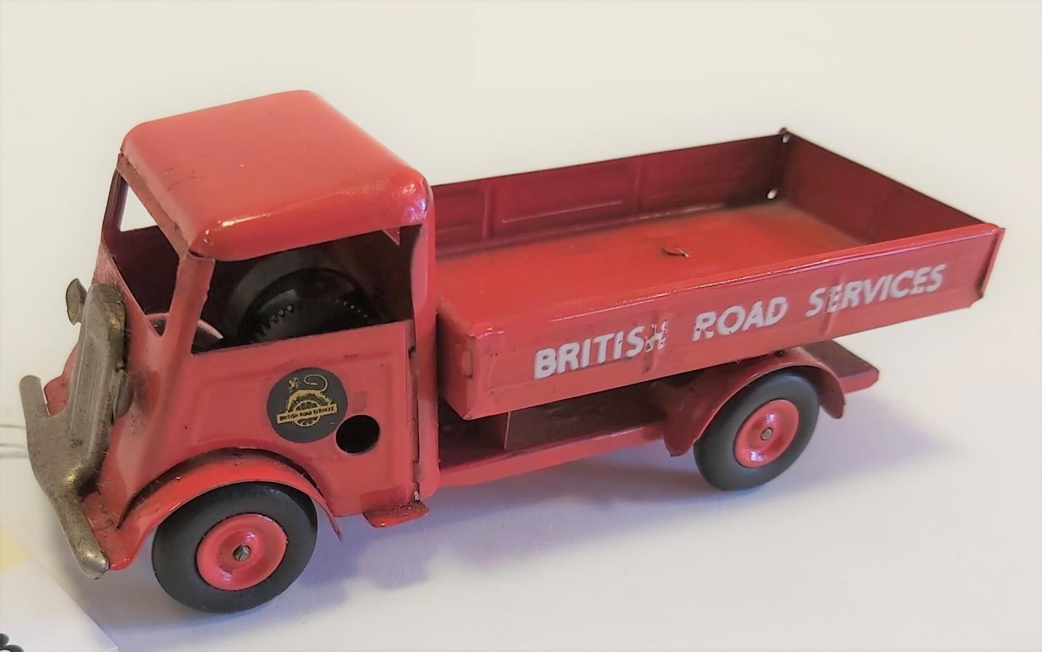 Tri-ang Minic tinplate clockwork Open Lorry. A short nose example in bright red British Road Service
