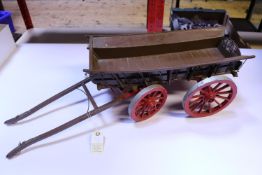 A large scale kit-built painted wooden model of a 4-wheel horse drawn farmer's wagon. A well