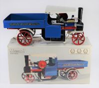 A Mamod Steam Wagon. An example finished in blue, red, white and black livery, red spoked metal