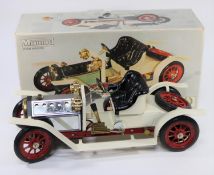 A Mamod Steam Roadster. An example finished in cream with red chassis, with plated bonnet, red