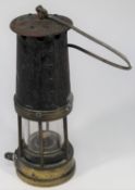 A Davy Miner's Lamp. Brass and steel construction with 212 stamped into brass reservoir section