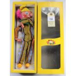 A Pelham Puppet Clown SM1. A Clown in multi striped/patterned one piece, with pink hair and yellow