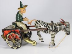 A rare Lehmann 1920s tinplate Zikra Zebra Cart No.752. Clockwork 2-wheel cart with driver in green