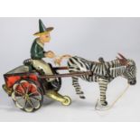 A rare Lehmann 1920s tinplate Zikra Zebra Cart No.752. Clockwork 2-wheel cart with driver in green