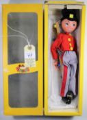 Pelham Puppet Soldier 'Fritzi'. In a scarlet jacket, with yellow buttons, grey trews with red stripe