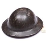 A WWI Brodie’s pattern steel helmet, dark green painted finish (some wear), with plain red oval