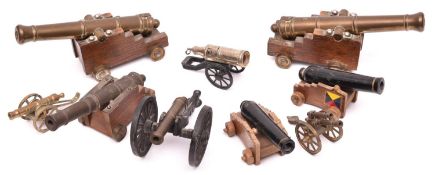A pair of brass barrelled model Napoleonic period naval cannon, stepped wooden carriages, brass