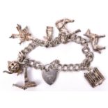 A silver coloured charm bracelet, double link chain, with tiny stage and 3 dancing girls with
