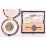An ERII 9ct gold sweetheart badge of The R Engineers, HM G Co Ltd B’ham 1969, and an enamelled Geo