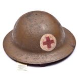 A WWI US Red Cross Brodie’s pattern steel helmet, painted red cross on white in roundel, leather