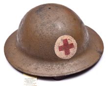 A WWI US Red Cross Brodie’s pattern steel helmet, painted red cross on white in roundel, leather