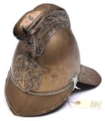 A fireman’s brass helmet by Merryweather, c 1900, with front and back peaks, ornamental crest and