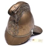 A fireman’s brass helmet by Merryweather, c 1900, with front and back peaks, ornamental crest and