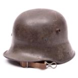 A German WWI M16 steel helmet, with original grey painted finish, the inside rear rim painted with