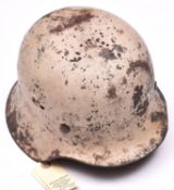 A Third Reich M42 steel helmet, with textured white camouflage finish for use on the Russian