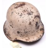 A Third Reich M42 steel helmet, with textured white camouflage finish for use on the Russian