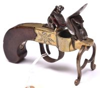 An early 19th century flintlock tinderlighter, in the form of a brass framed pocket pistol, frame