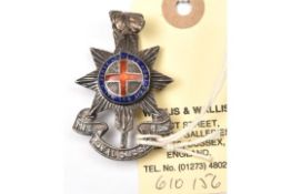 An Officer’s enamelled silver cap badge of The R Sussex Regt, HM JRG & Co B’ham 1932, brooch pin;