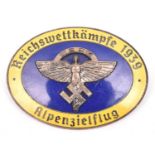 A Third Reich oval enamelled pin back badge, superimposed in the centre is the NSFK emblem in