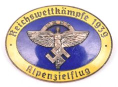 A Third Reich oval enamelled pin back badge, superimposed in the centre is the NSFK emblem in