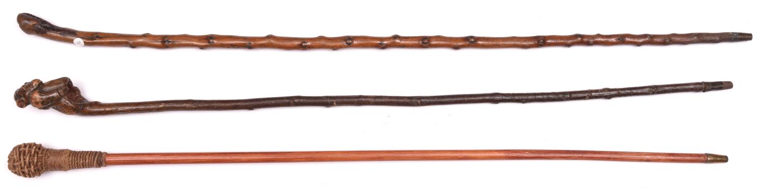 A knotted darkwood walking cane, the rootwood top carved in the form of a gorilla torso, brass