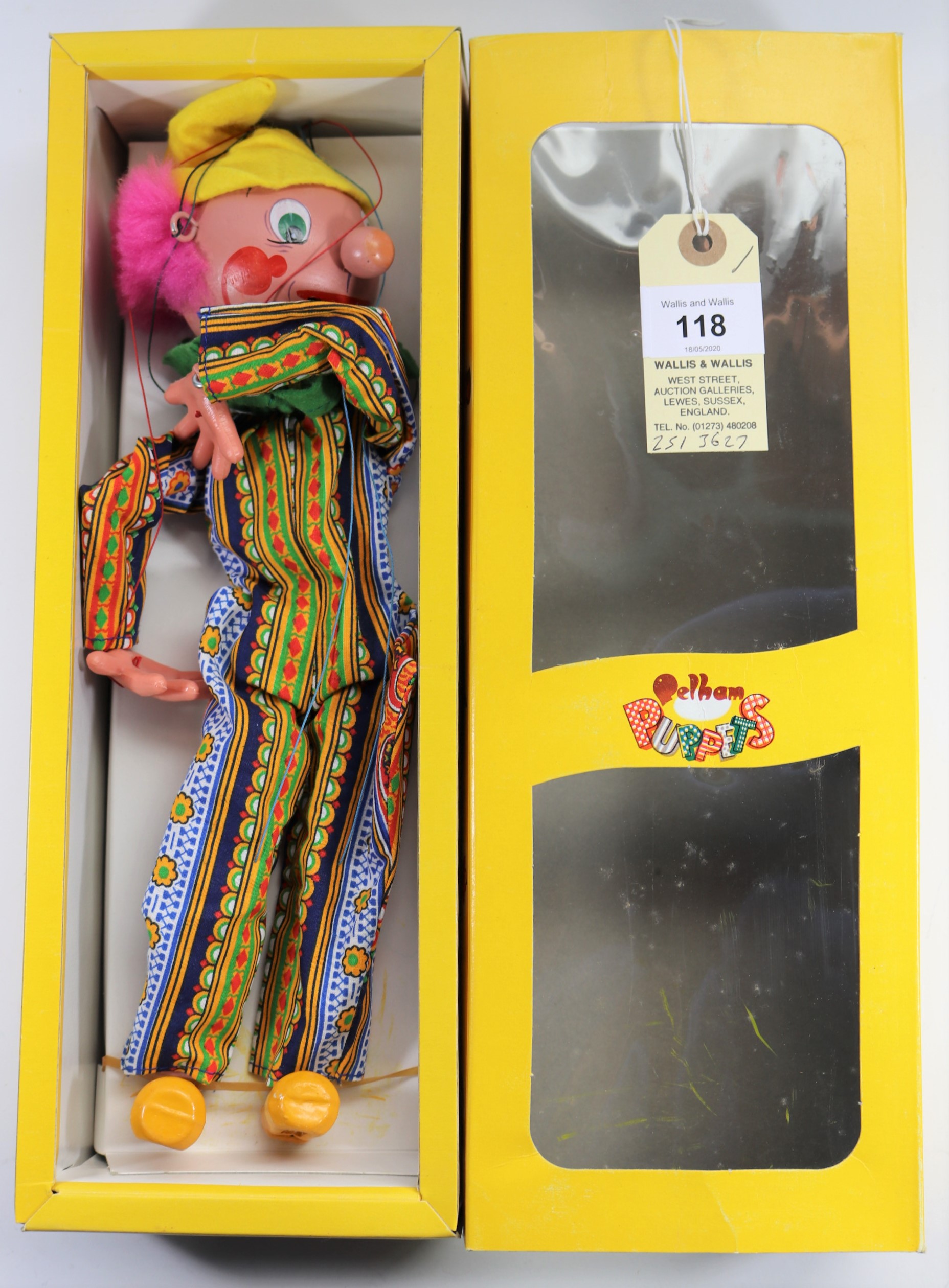 A Pelham Puppet Clown SM1. A Clown in multi striped/patterned one piece, with pink hair and yellow