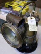 An LMS railway hand lamp. An LNWR pattern brass carbide inspector's lamp by Lucas. With Lucas '