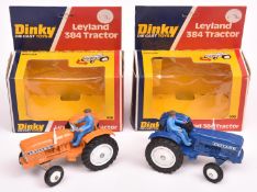 2x Dinky Toys Leyland 384 Tractor (308). One example in dark blue, the other in orange. Both with