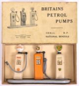 A scarce Britains Petrol Pumps set 101V. 3-pump set; Shell, B.P. and National Benzole. On a grey