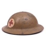 A WWI US Red Cross Brodie”s pattern steel helmet, painted red cross on white in roundel, leather