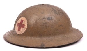 A WWI US Red Cross Brodie”s pattern steel helmet, painted red cross on white in roundel, leather