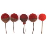 5 woollen ball plumes for 19th century shakos, comprising 4 dark red over grey and one small