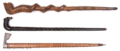 An Indian heavy ebony walking stick, deeply carved overall with spiral and chequered patterns,