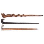 An Indian heavy ebony walking stick, deeply carved overall with spiral and chequered patterns,