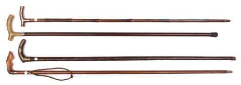 4 slender walking sticks: dark wood with iron handle decorated with Indian gold Koftgari foliate