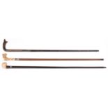 2 walking sticks pale wood with ivory handle carved with roses entwined around a twisted stump;