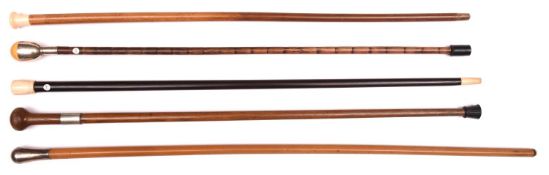 5 walking canes: malacca with plain unmarked silver top; malacca with ivory “mushroom”top, carved