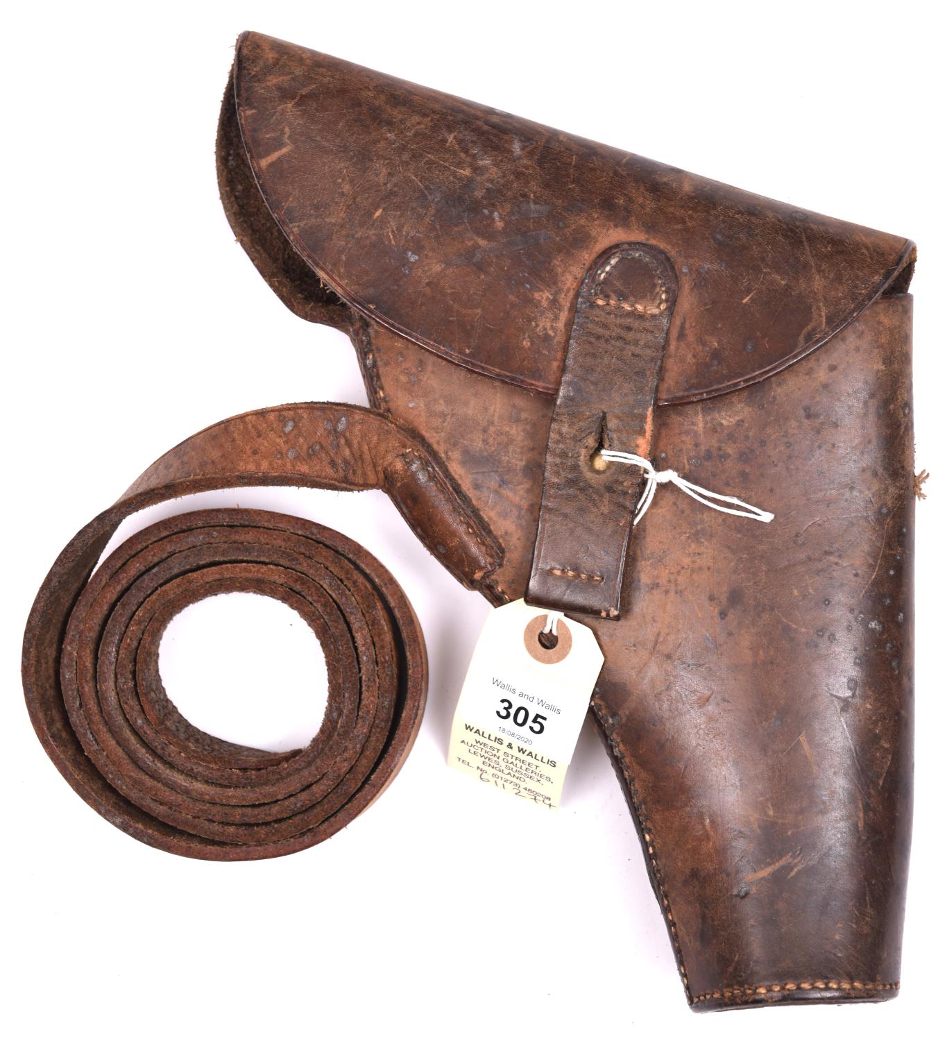 A scarce WWII flap top leather holster for a flare pistol, with leather belt loop stamped “E