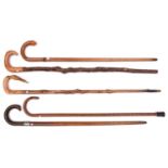 5 walking sticks: pale wood with crook handle terminating in composition lion's head with glass