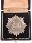 A Third Reich “Ostvolker” medal, 1st class in silver (grey metal) with swords, in its fitted case.