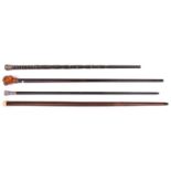 4 walking canes: varnished dark wood with large composition monkey head top with glass eyes (one ear