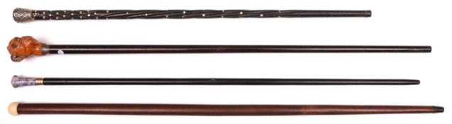 4 walking canes: varnished dark wood with large composition monkey head top with glass eyes (one ear