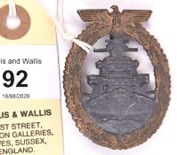 A Third Reich High Seas Fleet badge, gilt washed wreath with grey centre, and distinctive recessed