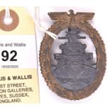 A Third Reich High Seas Fleet badge, gilt washed wreath with grey centre, and distinctive recessed